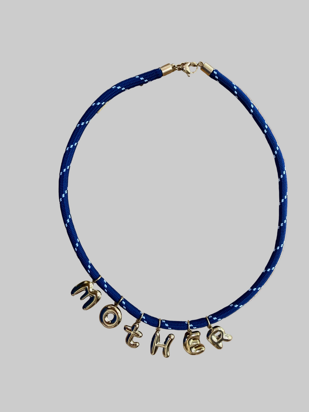 Blue necklace with gold charms spelling 'MOTHER' 