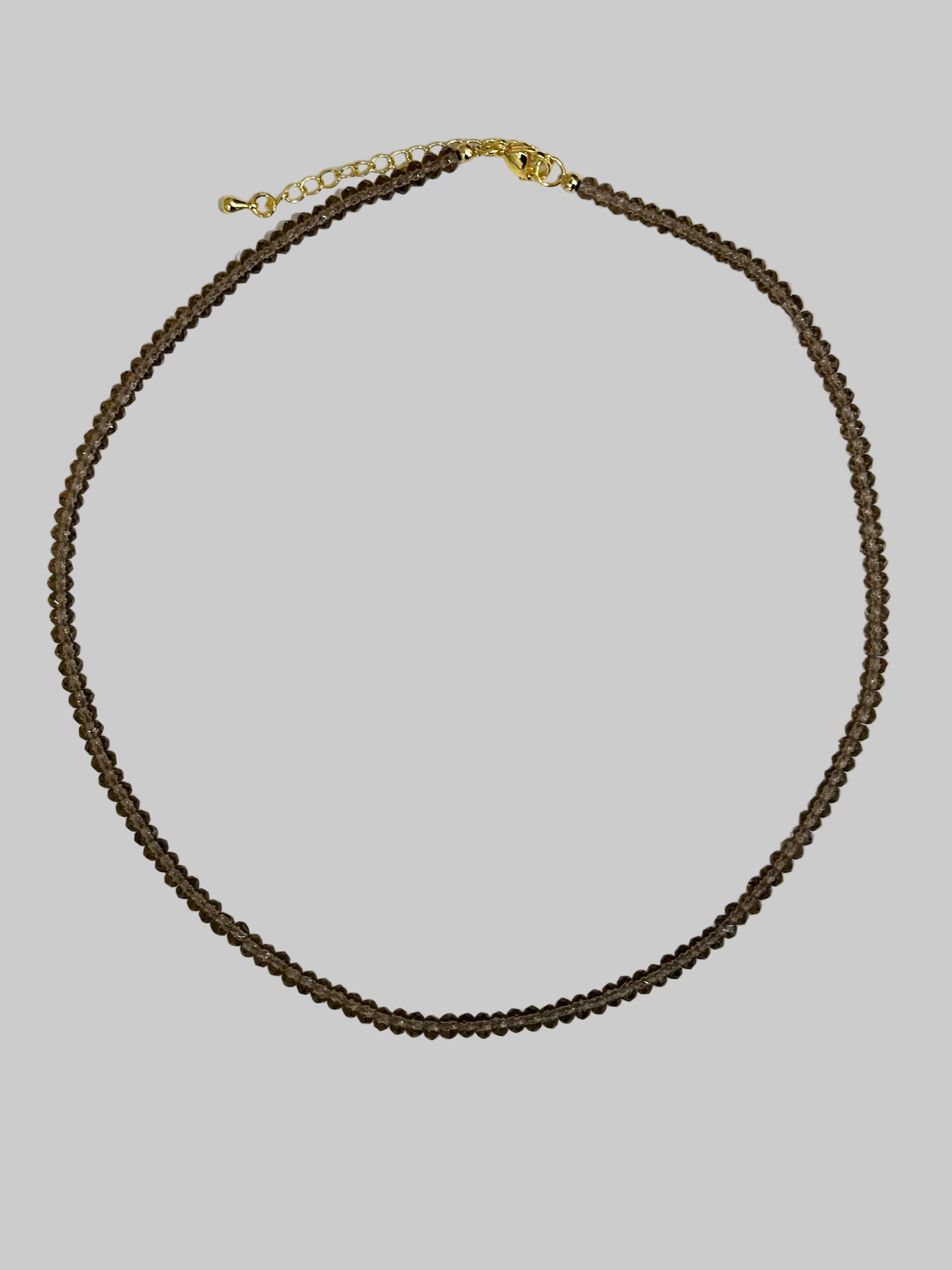 Brown beaded necklace with a gold clasp 